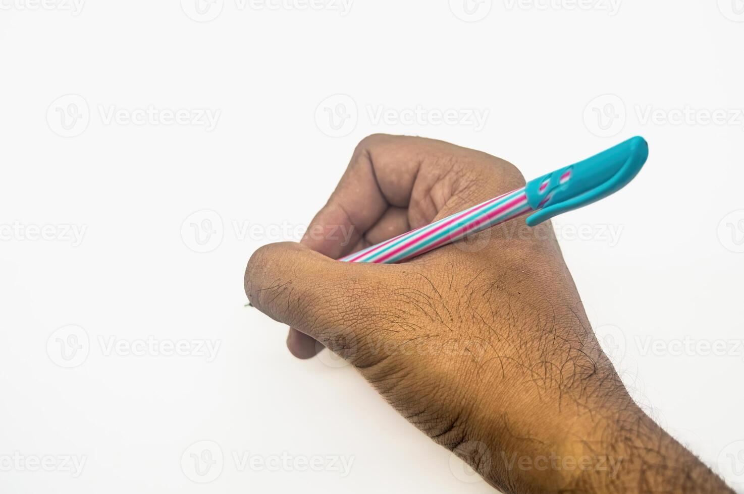 A close up of a hand holding a colorful pen, poised to write on a blank white surface. The image highlights the act of writing or drawing, emphasizing creativity and expression photo