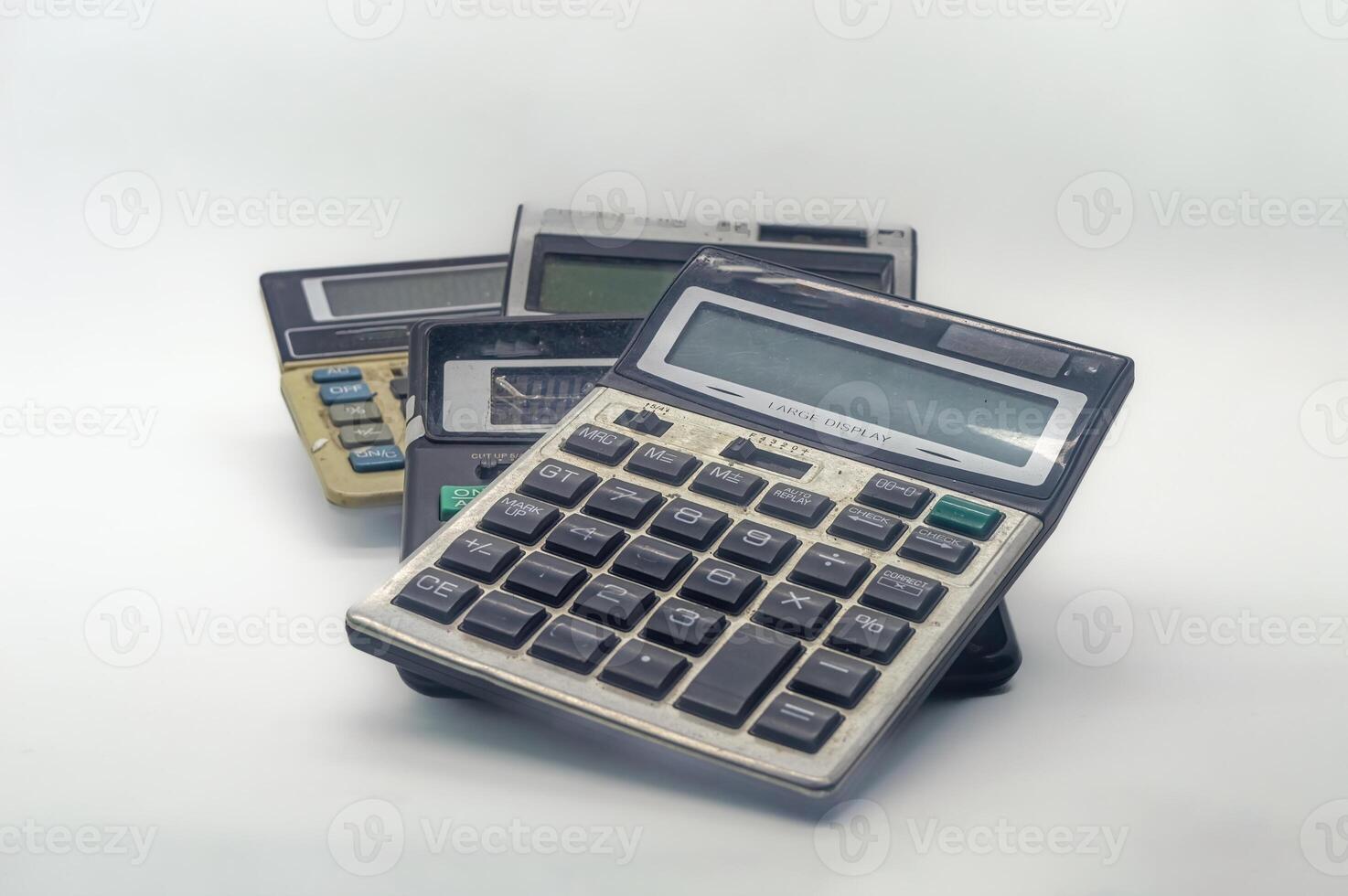 A pile of old calculators symbolizes inflation, representing outdated financial tools and the increasing cost of living photo