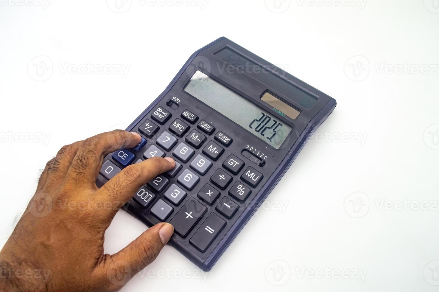 A hand using a calculator with the number 2025 displayed on the screen. The calculator is on a white background photo