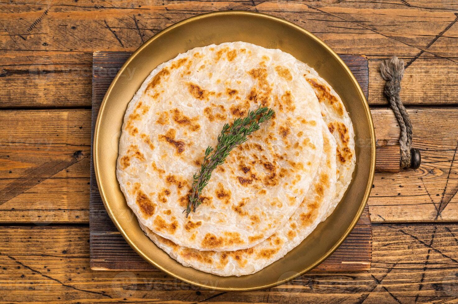 Potato Stuffed Flat Bread Aloo paratha, Traditional Indian food. wooden background. top view photo
