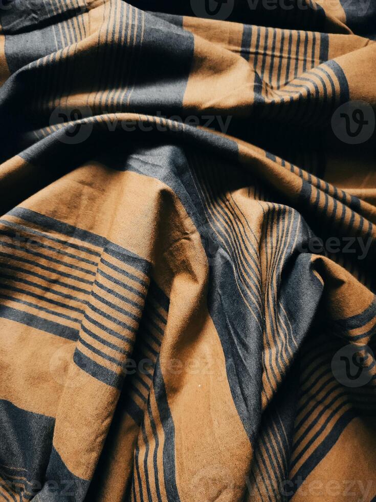 The yellow, black and eye-catching checkered cover features a classic pattern that exudes timeless elegance and cultural significance photo