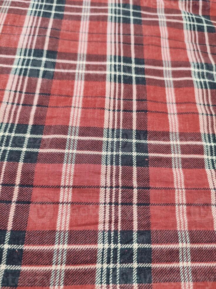 The pattern and background of the fabric has a red checkered motif photo