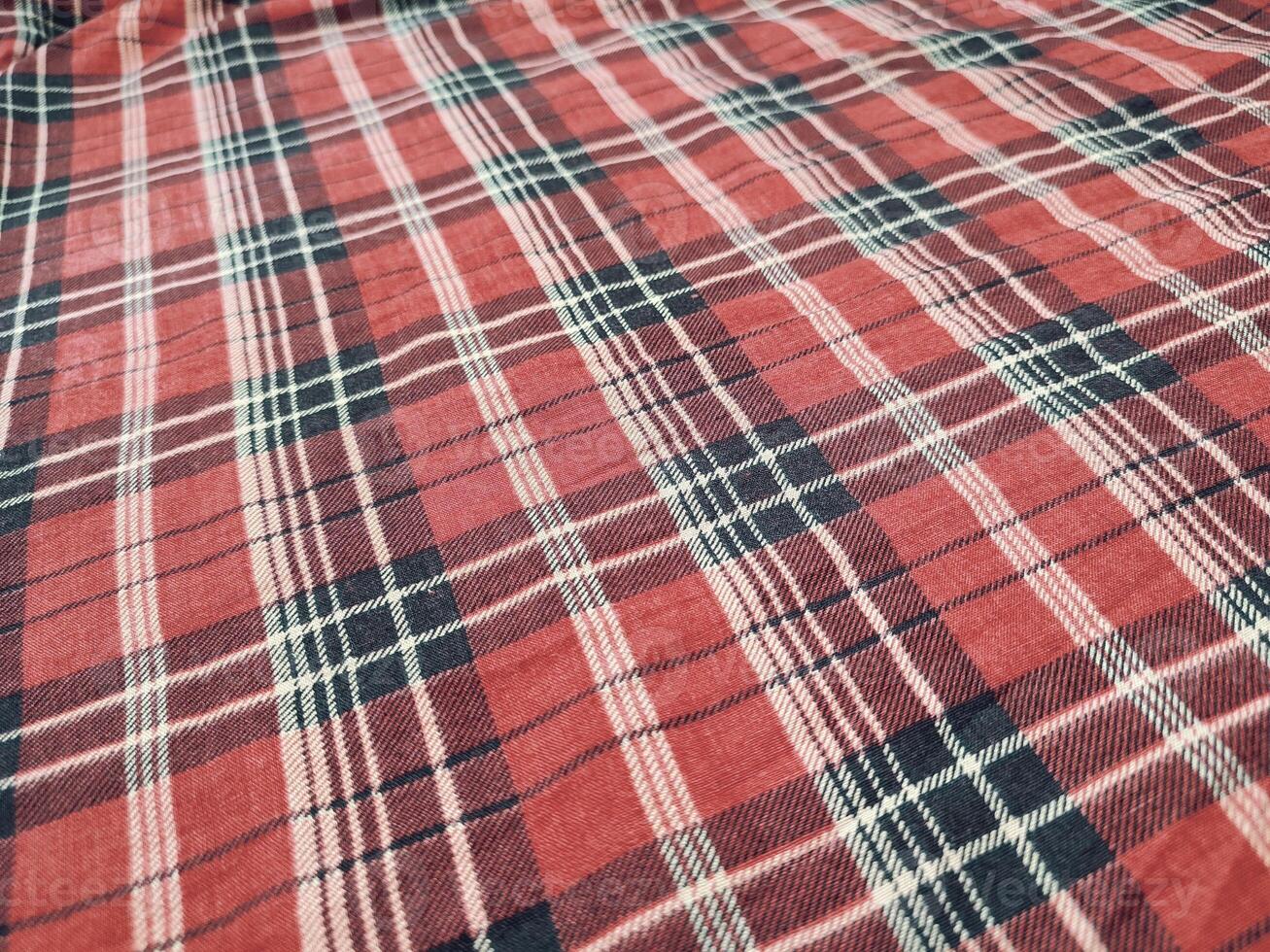 The pattern and background of the fabric has a red checkered motif photo