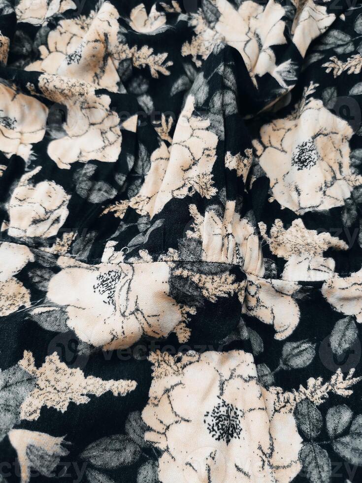A series of abstract multi-colored rose flower patterns in medium color, rose material fabric solid black background photo