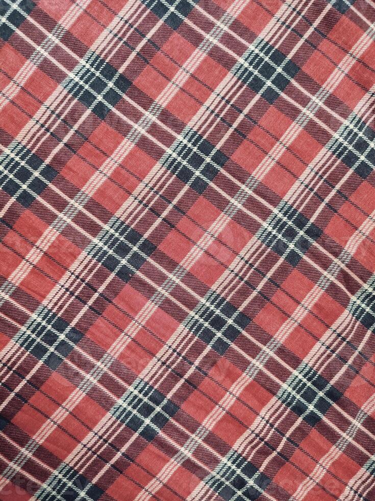 The pattern and background of the fabric has a red checkered motif photo
