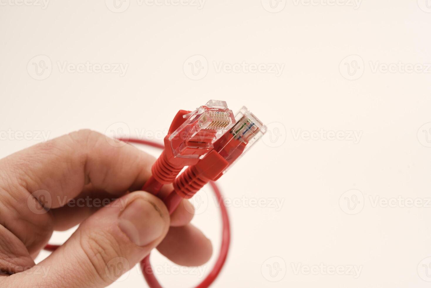 Red internet cable in hand. The RJ-45 connector. photo