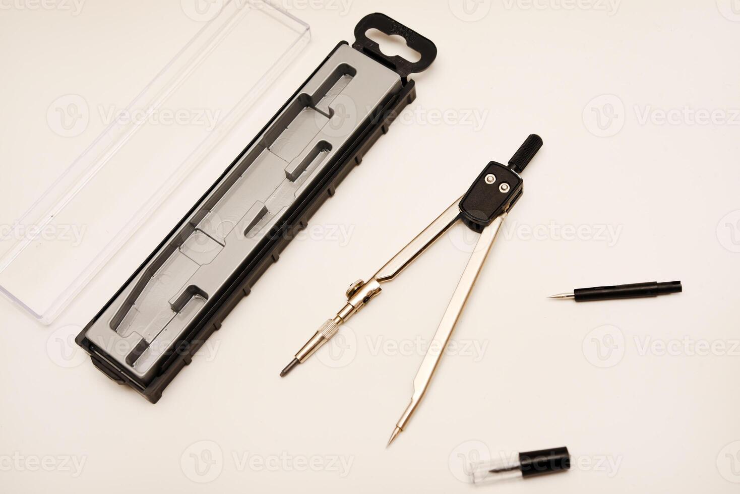 Black compasses on a white background. A drawing tool. photo