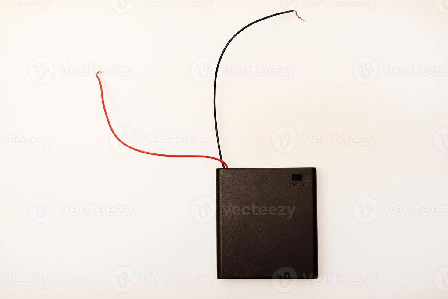 Portable battery pack with wires on a white background. photo