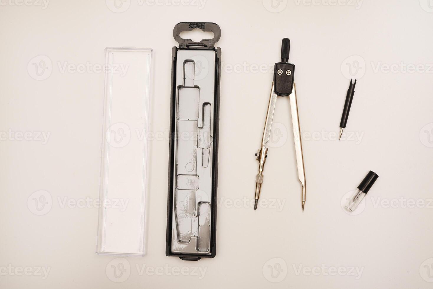 Black compasses on a white background. A drawing tool. photo