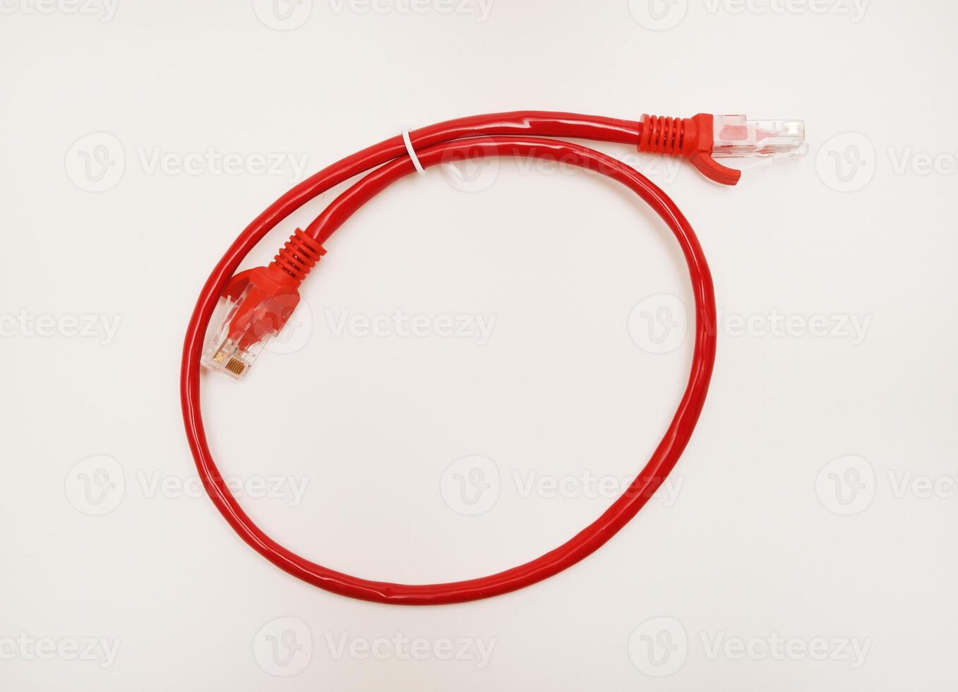 Red internet cable on a white background. The RJ-45 connector. photo