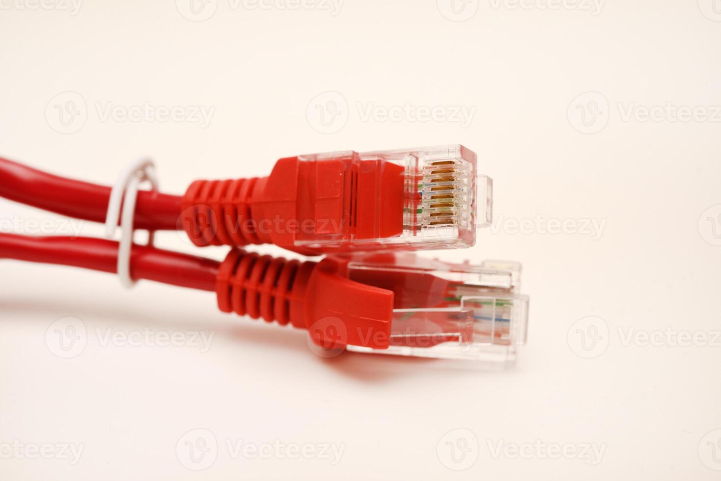 Red internet cable on a white background. The RJ-45 connector. photo