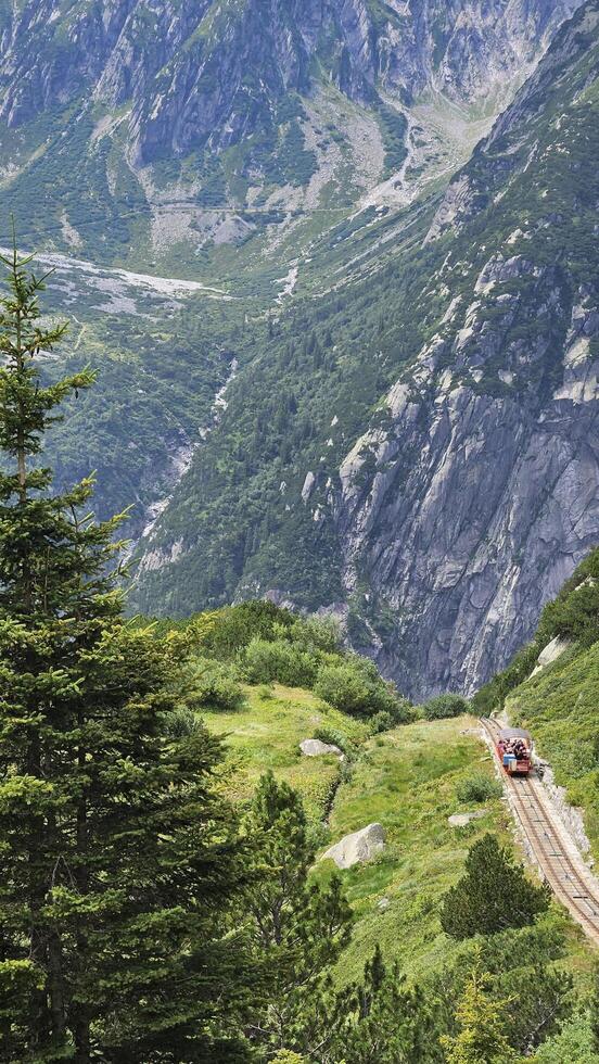 A little red train going up the mountain photo