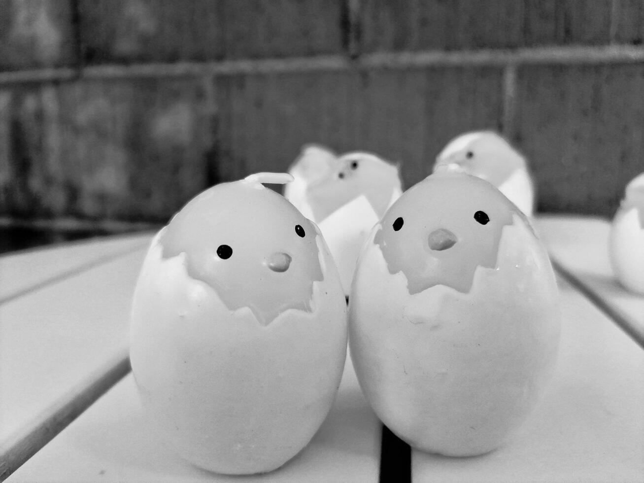 A handful of candles in the shape of chicks. Photo in black and white