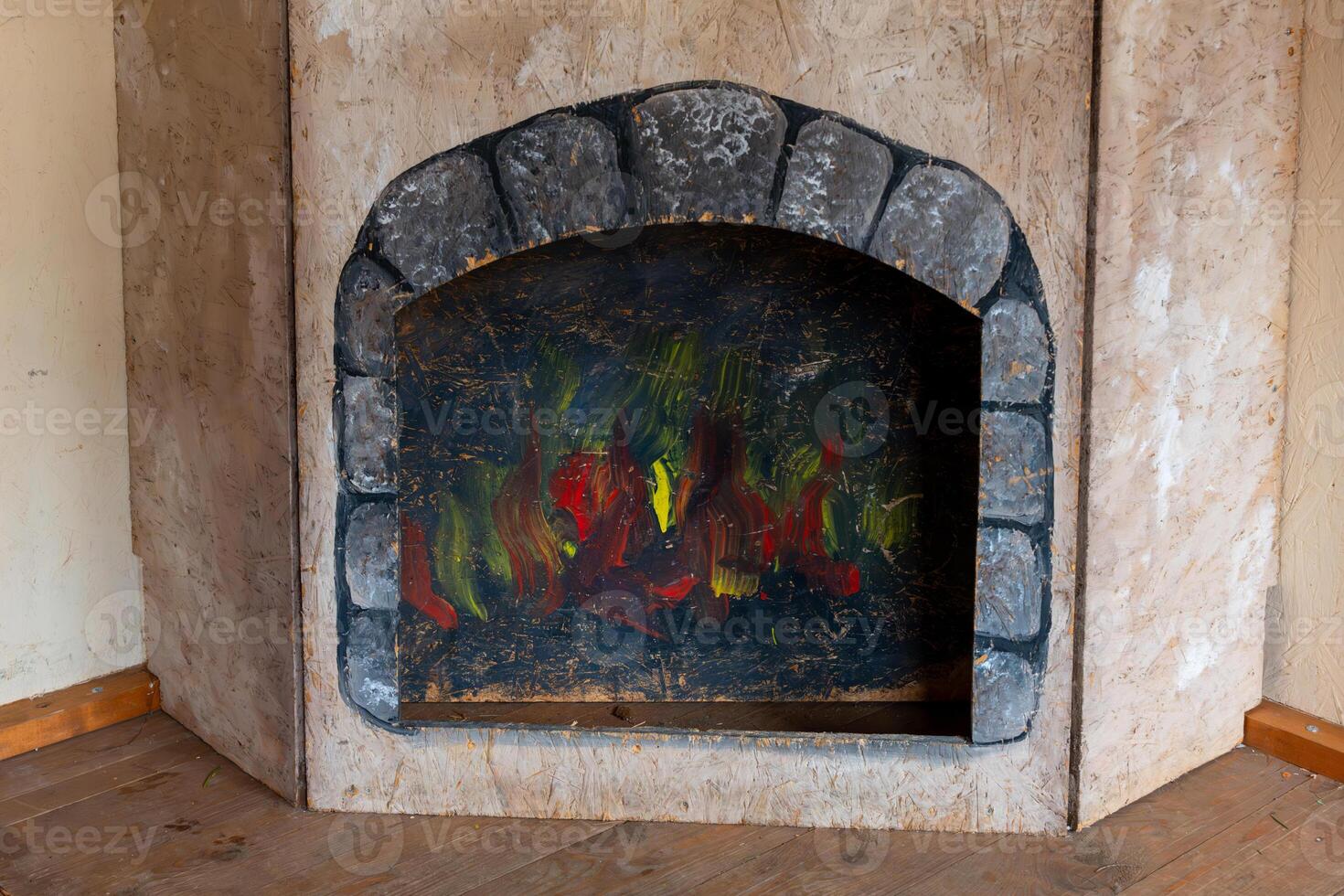 Cozy fireplace with vibrant artwork resembling flames in a rustic interior setting photo