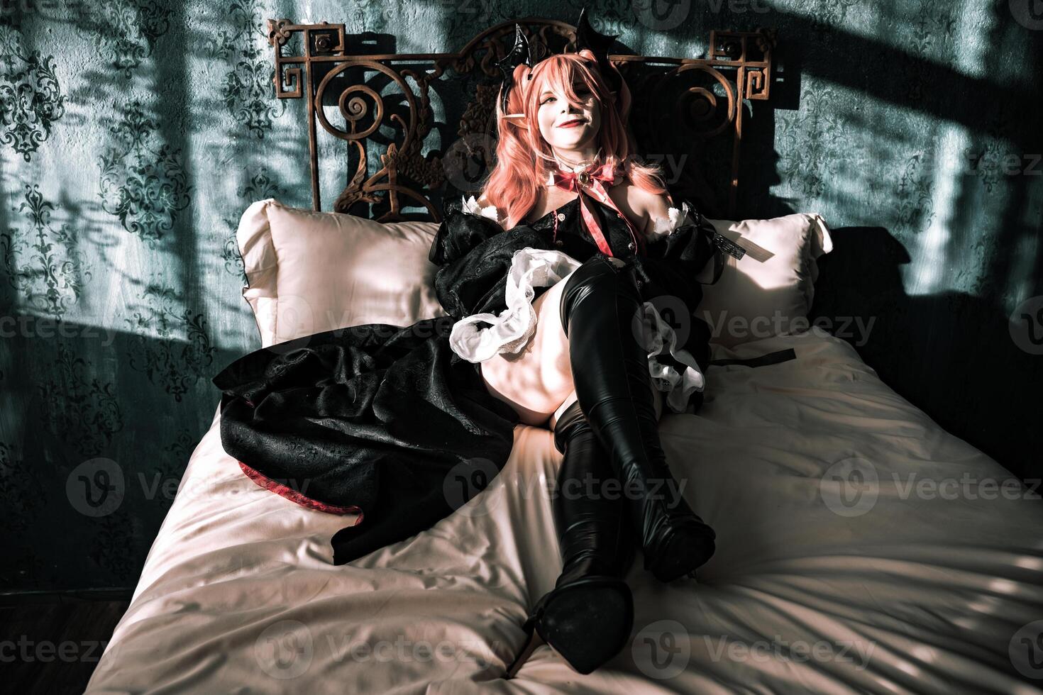 Character poses on a vintage bed with dramatic shadows and unique lighting in an artistic setting photo