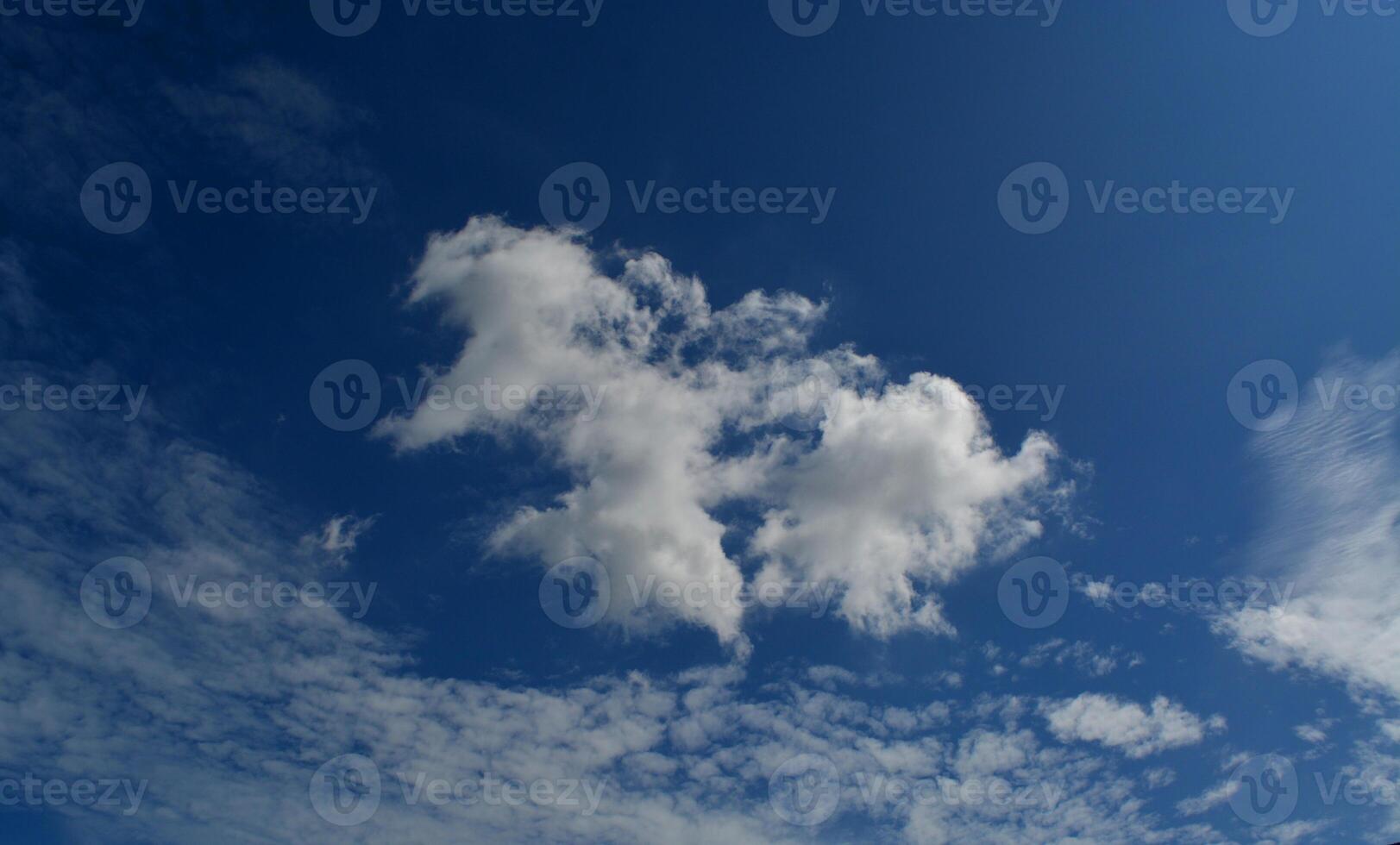 The sky is blue with a few hanging white clouds. photo