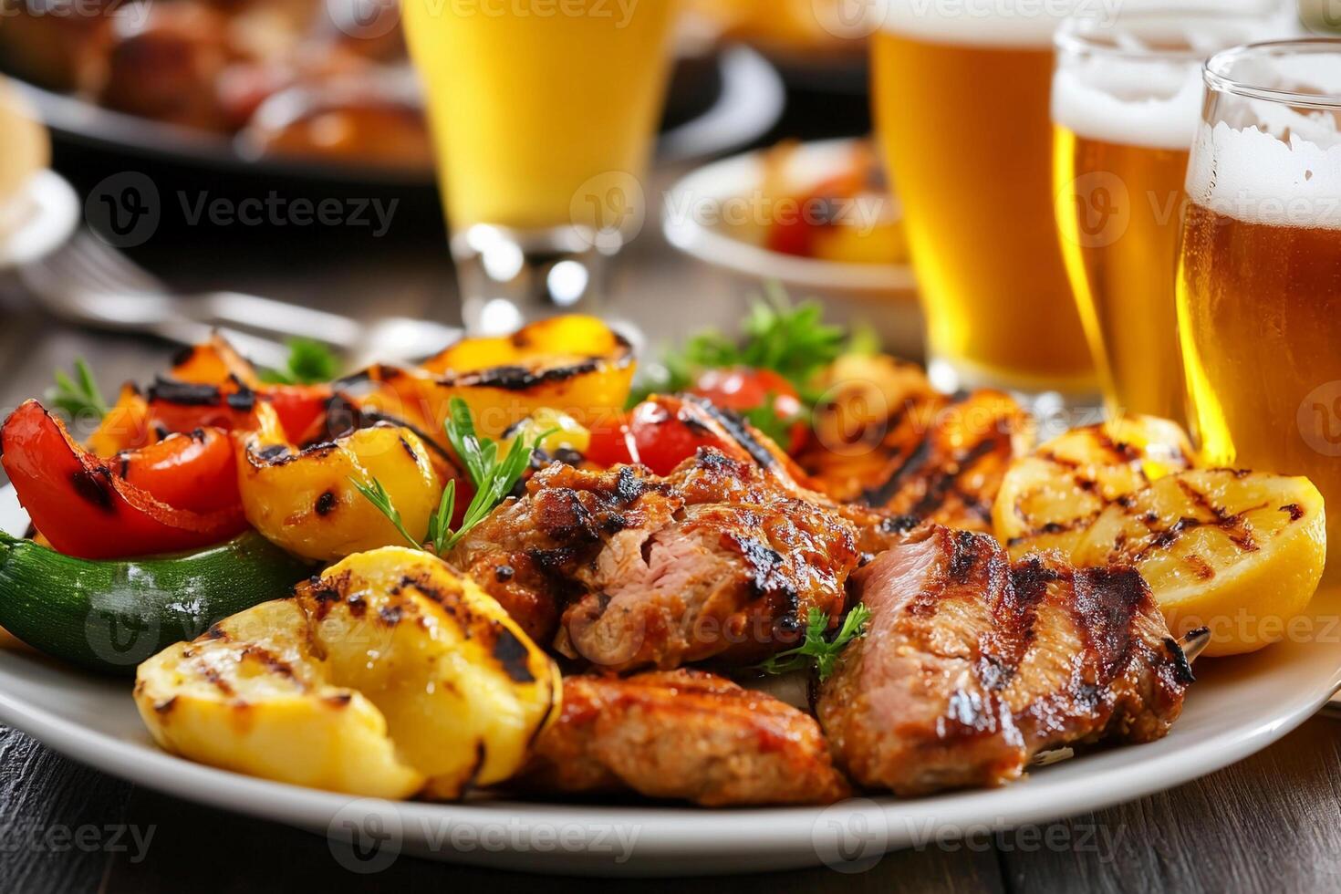 Grilled meat and vegetables with beer on a table photo