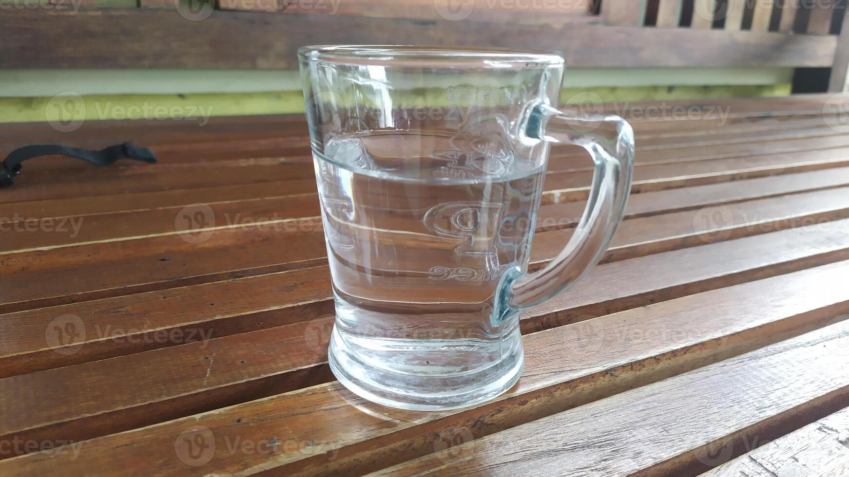 glass on wooden chair photo