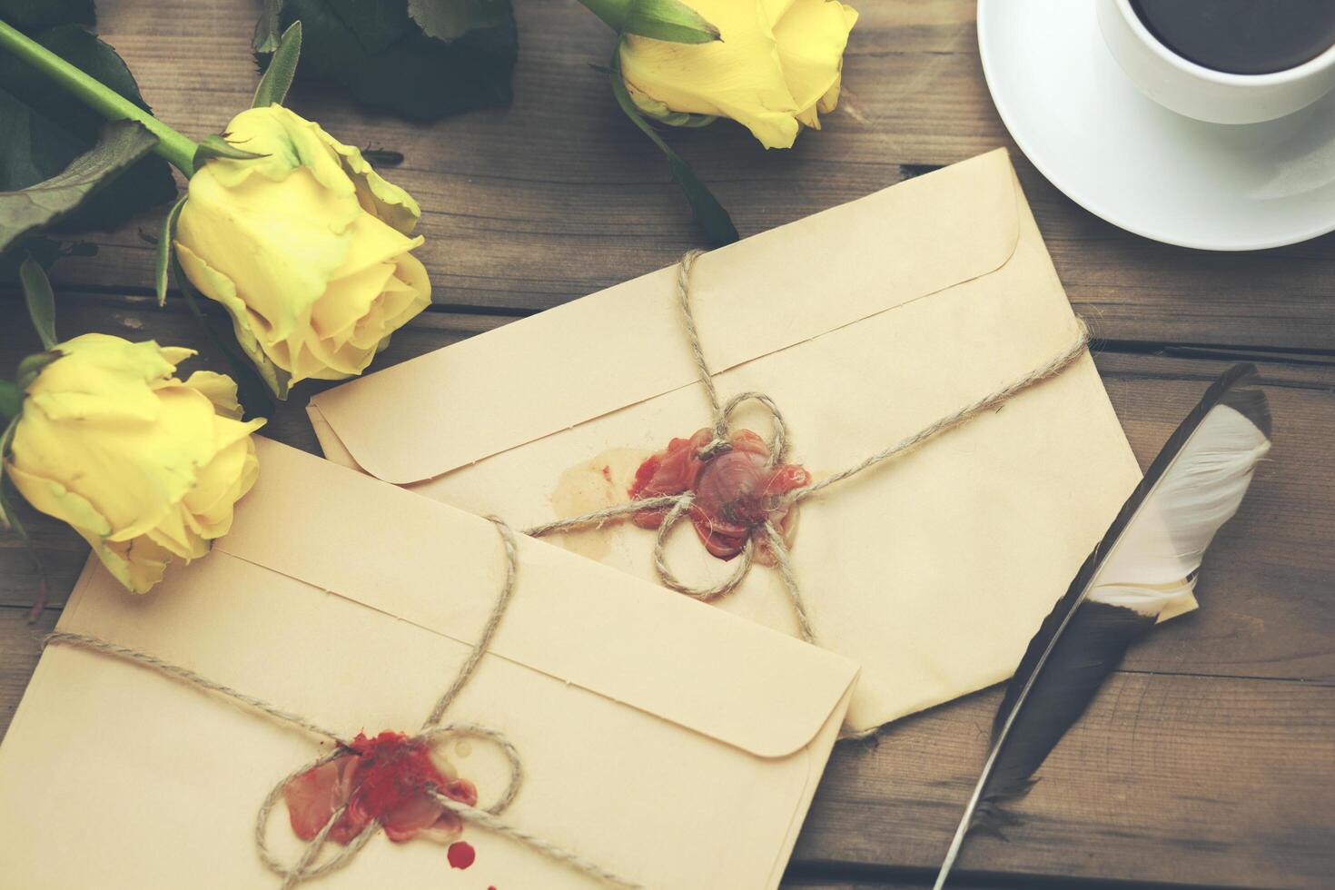 yellow rose with letters and coffee on table photo
