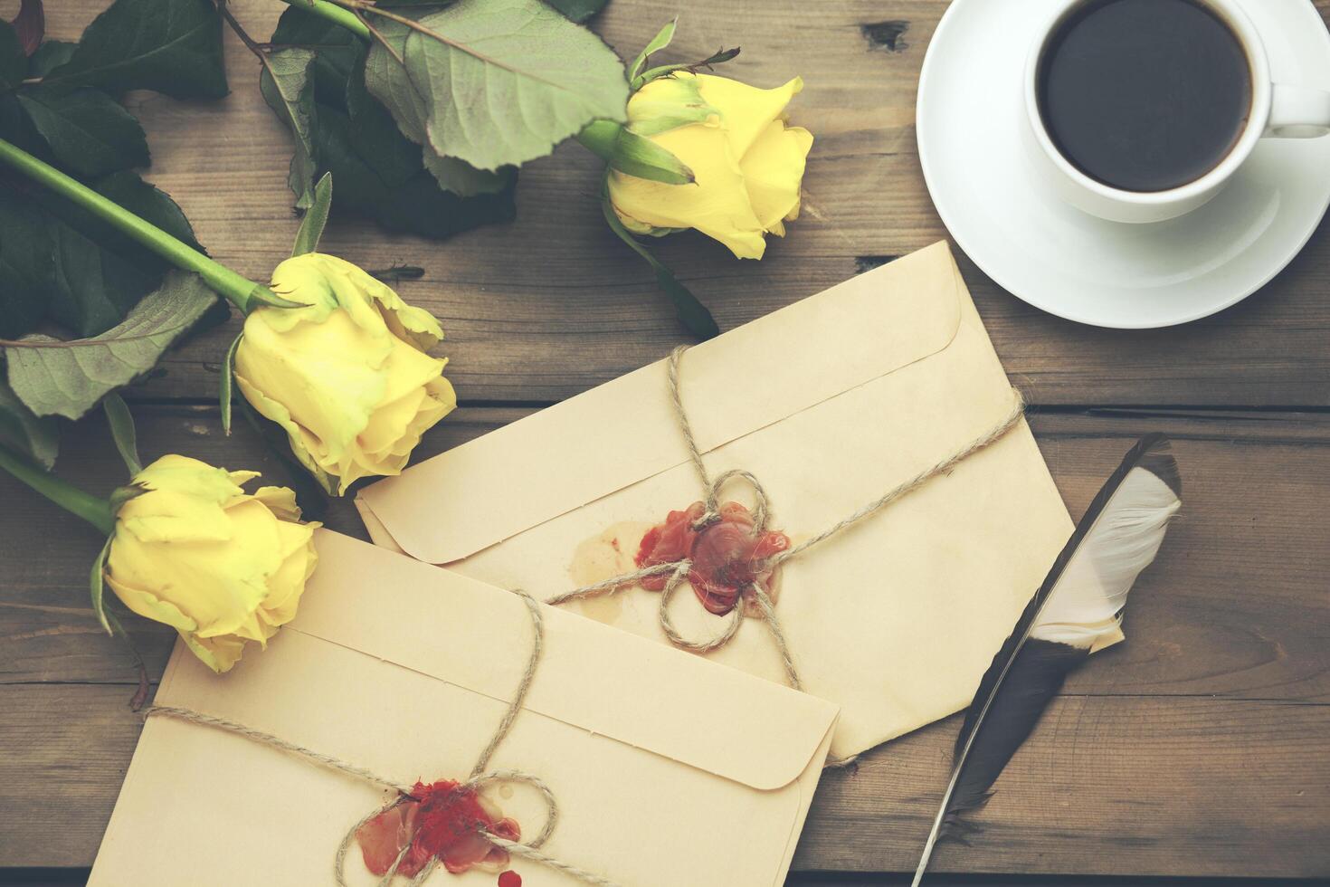yellow rose with letters and coffee on table photo