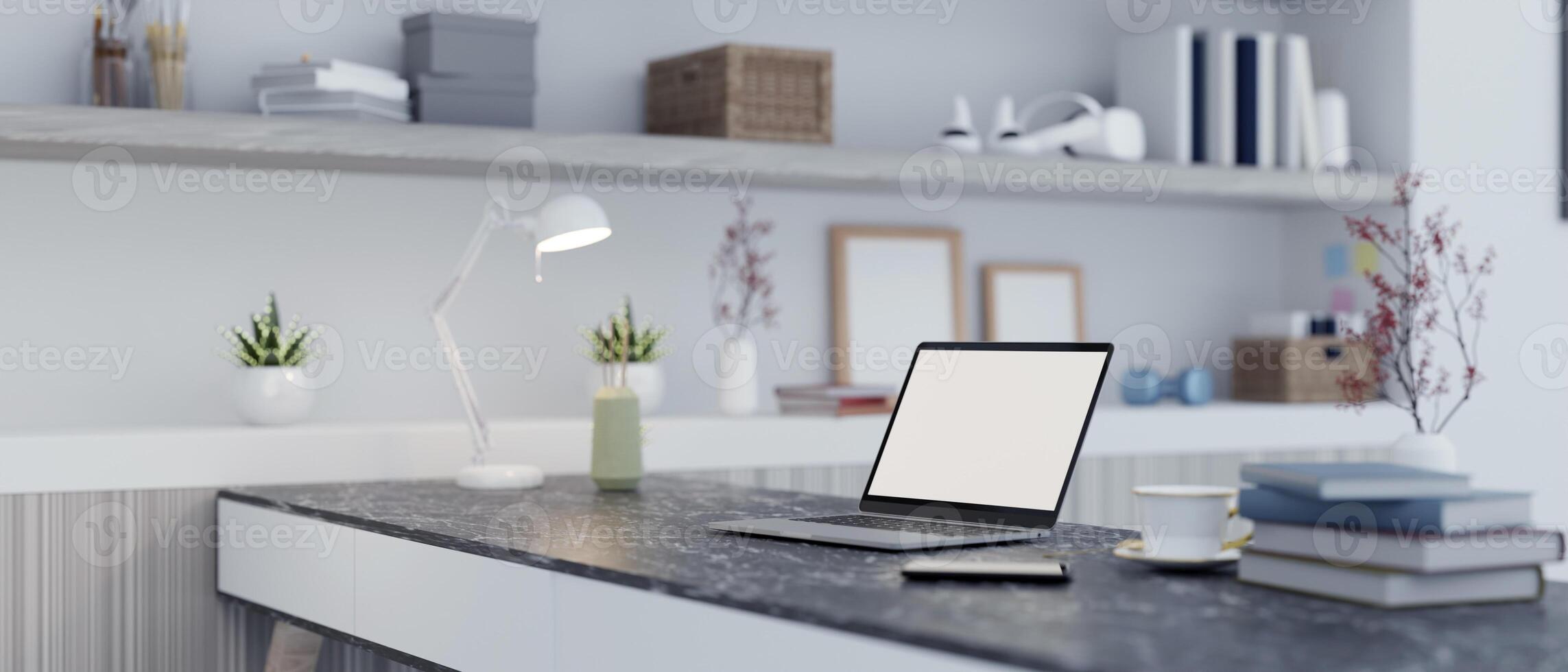 A laptop with a white desktop mockup and decor on a table in a modern home office workspace. photo