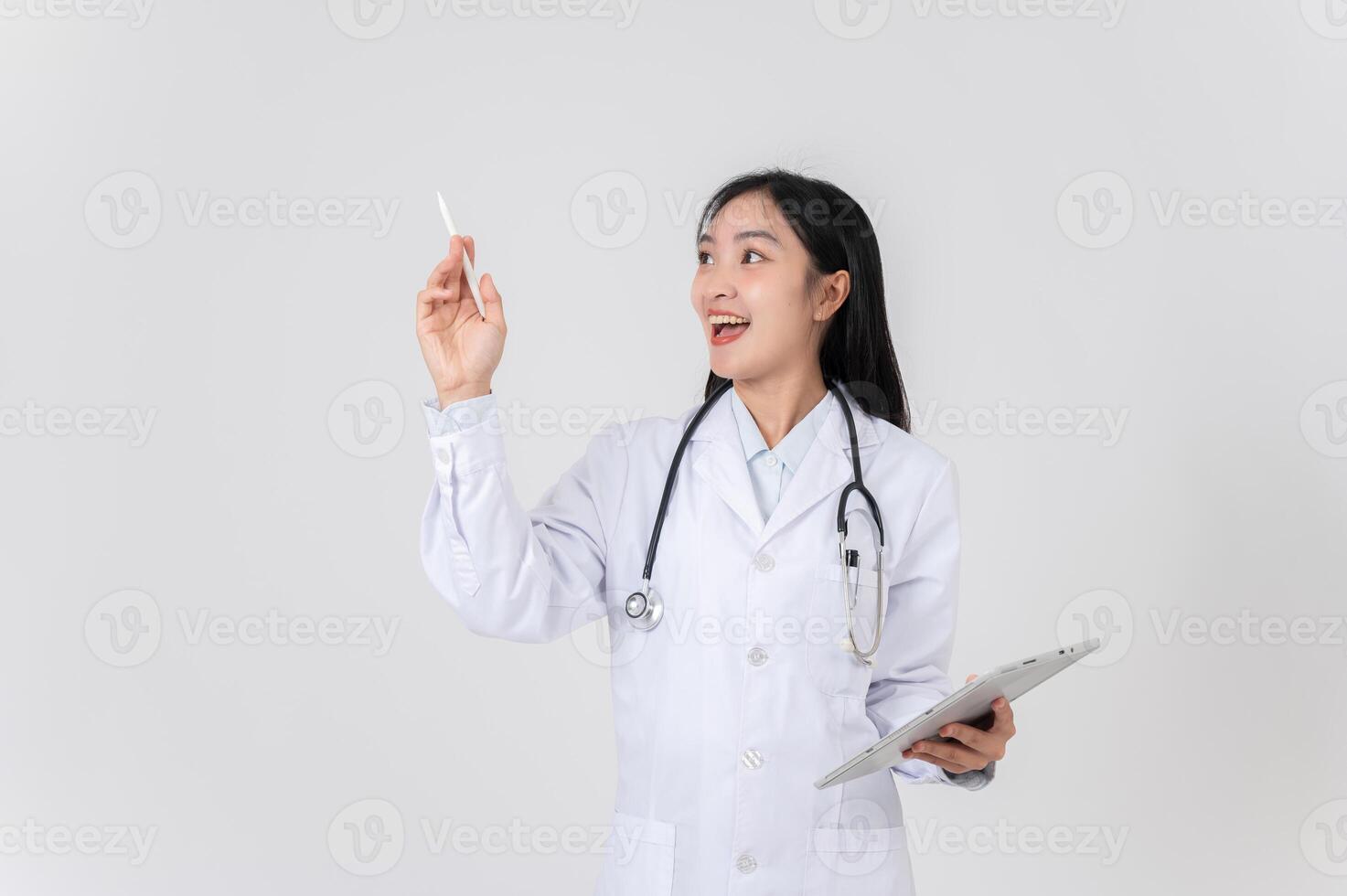 A doctor holding a digital tablet, pointing, and looking to the side as if thinking of an idea. photo