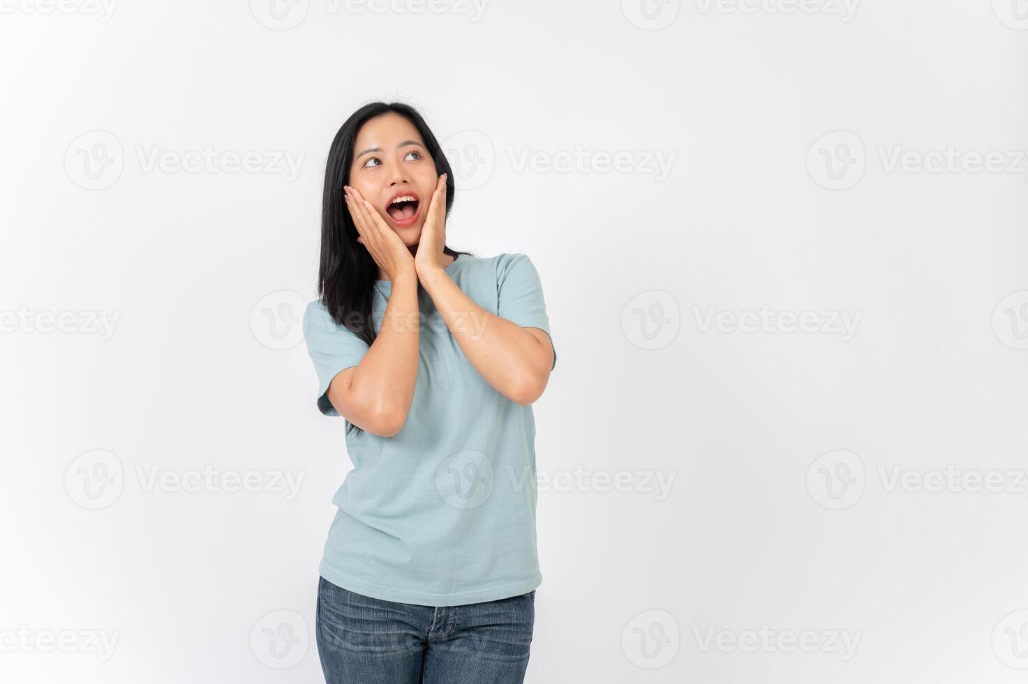 An excited Asian woman on a studio background with a surprising face expression. wow, amazed photo