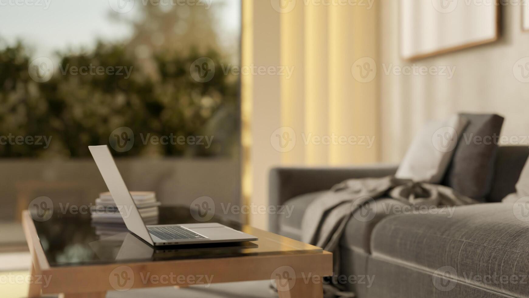 A close-up side view of a laptop on a coffee table in a modern and comfortable living room. photo
