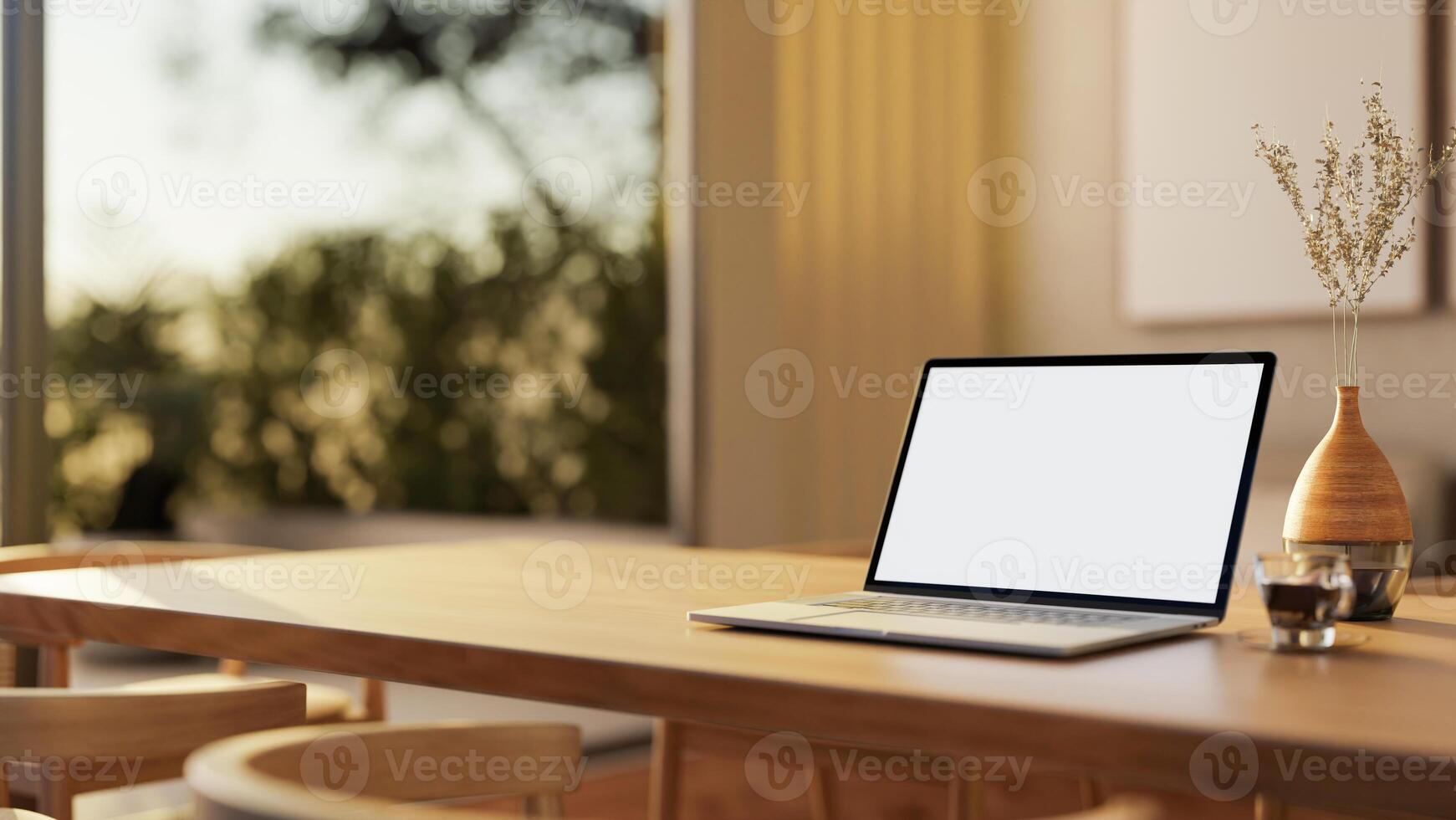 A close-up of a laptop with a white screen mockup on a hardwood dining table in a contemporary home. photo