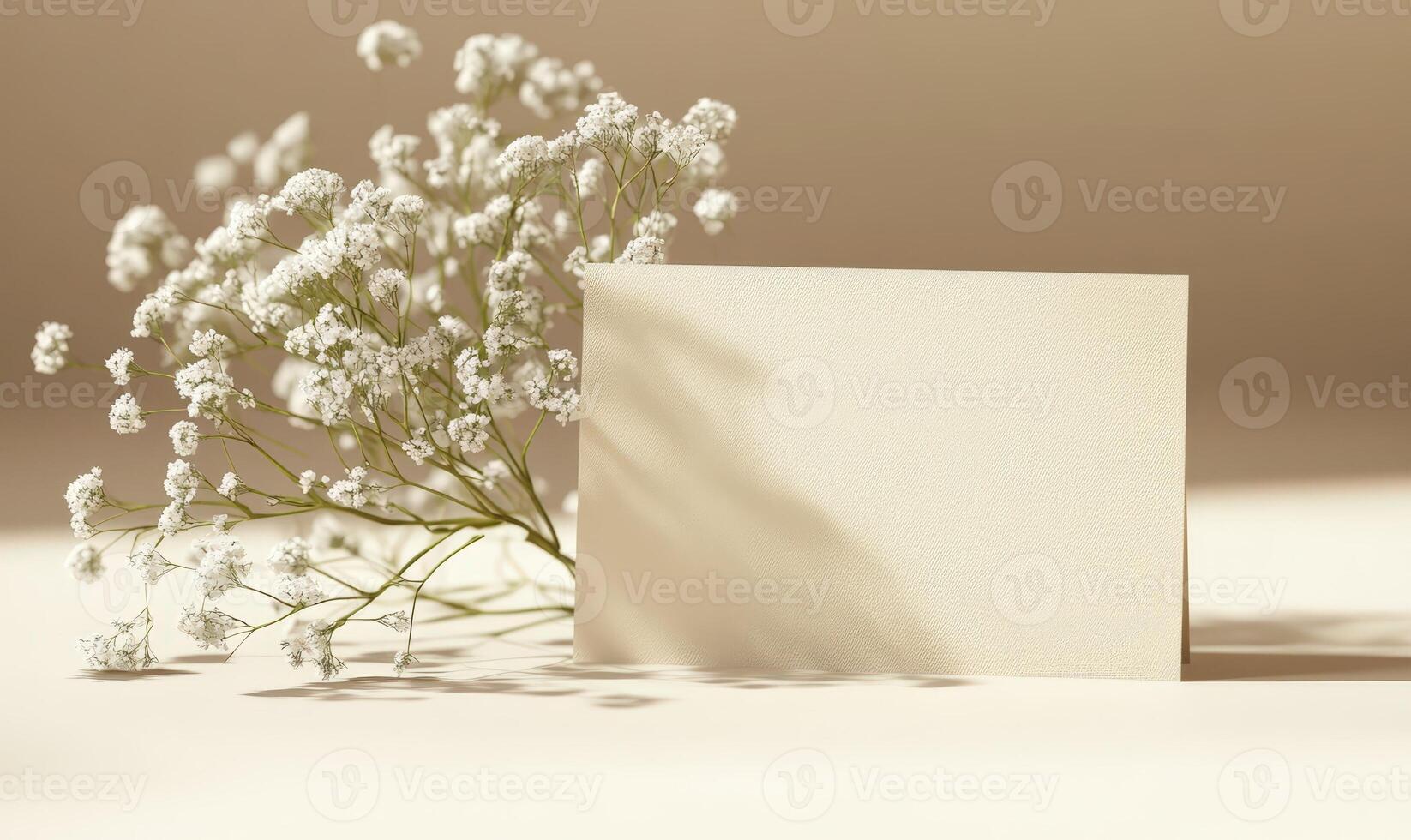 Minimalist blank card mockup featuring delicate eucalyptus foliage, soft white blossoms against neutral backdrop, ideal for wedding stationery photo