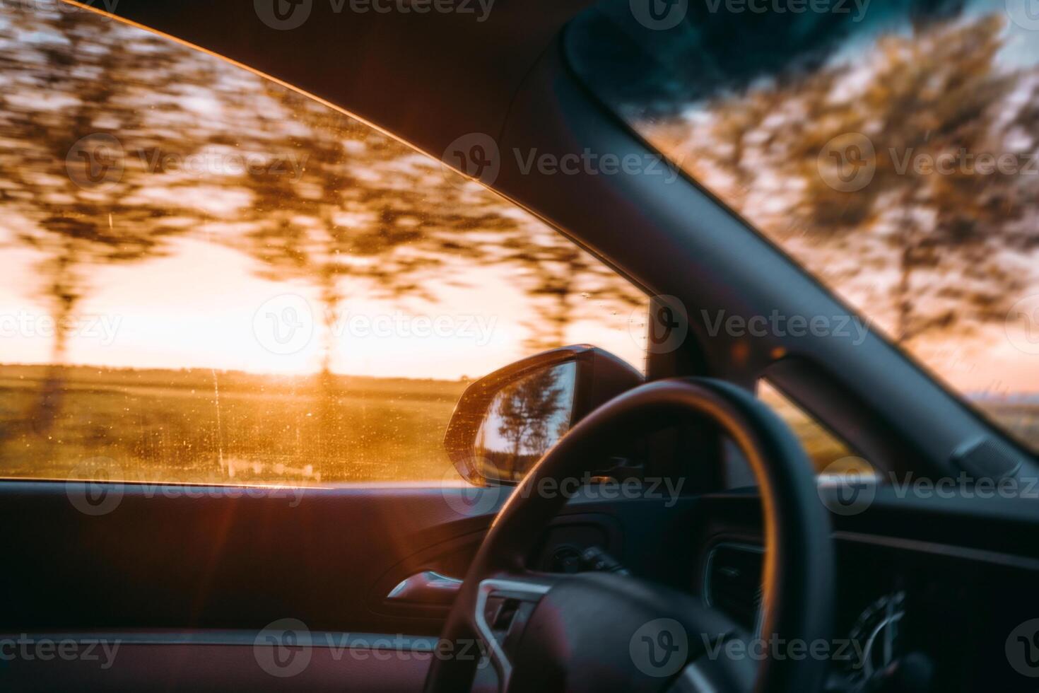 A car is driving on the road under the sunset photo