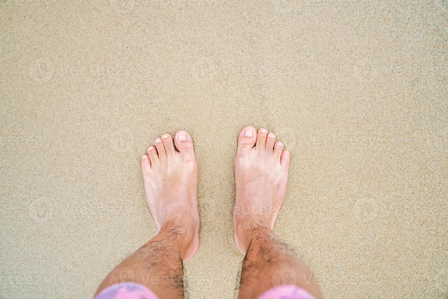 barefoot on the yellow clean beach photo