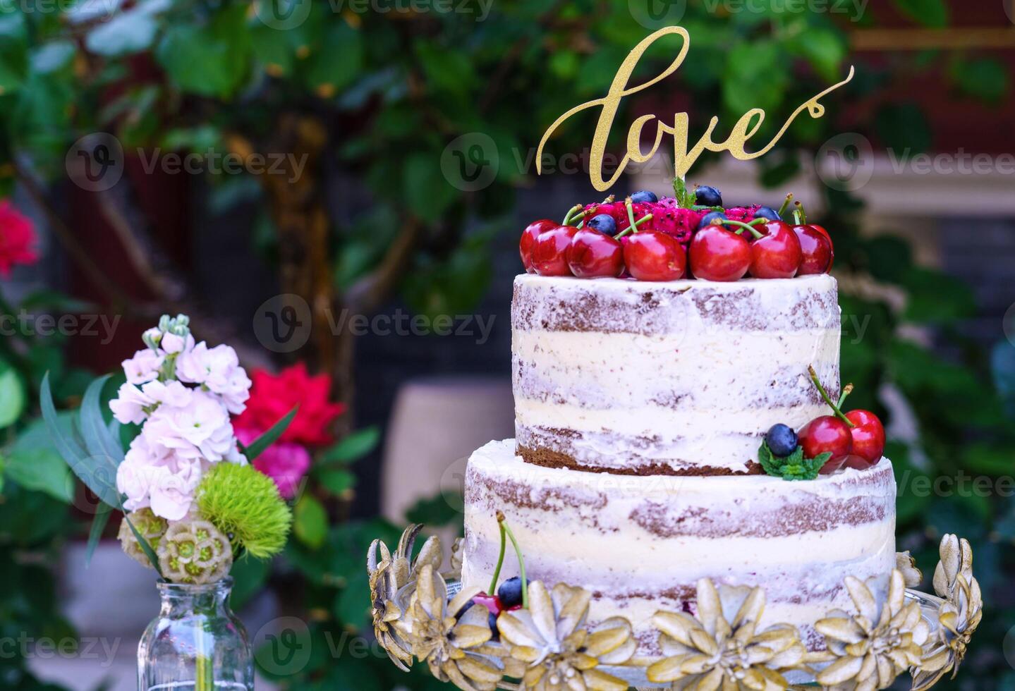 Multilayered wedding cake covered in white icing sugar photo
