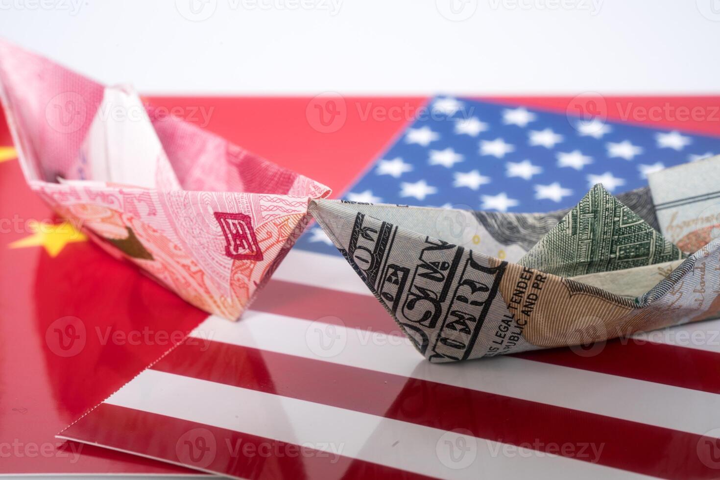 Paper folding ship of Dollar and Yuan currency photo