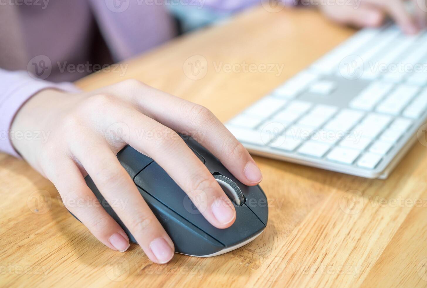 Girl's hand with computer mouse and keyboard photo