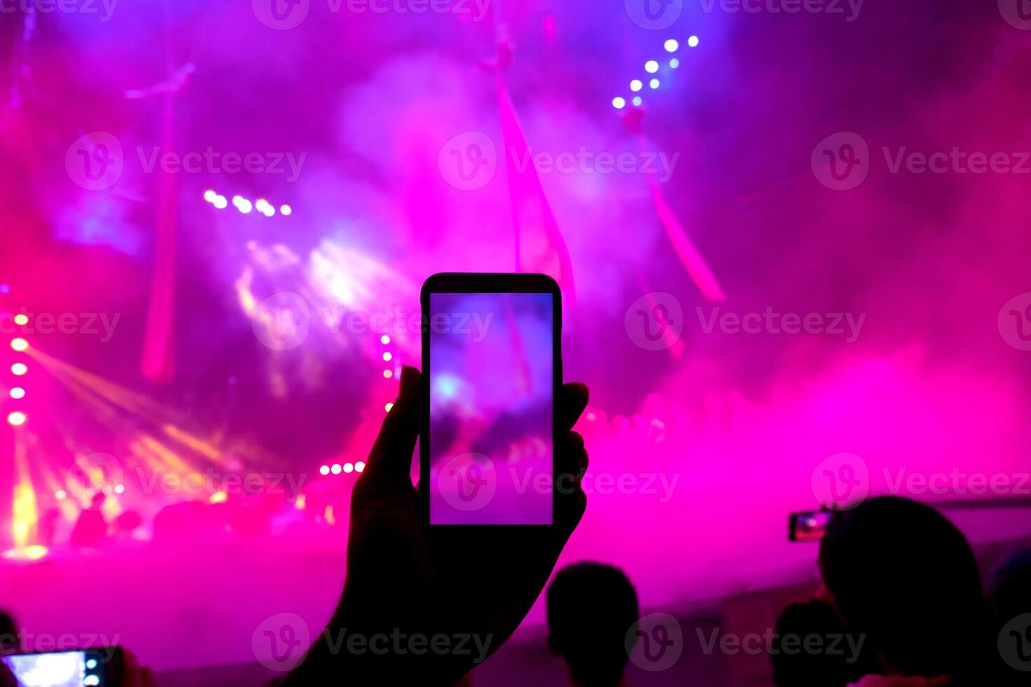 hand holding smart phone record the music show photo