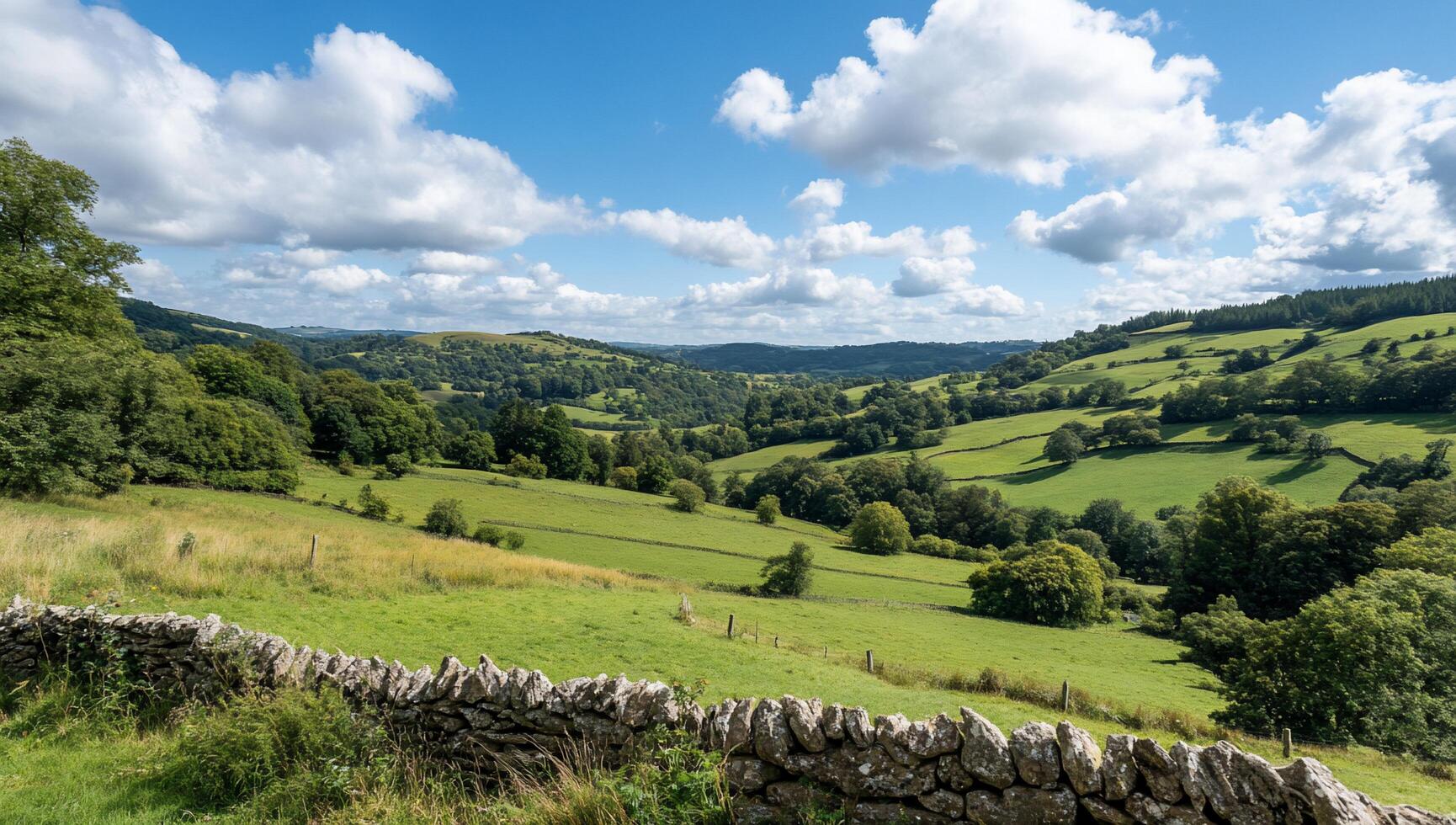 Scenic view of rolling hills and lush greenery under a blue sky. photo