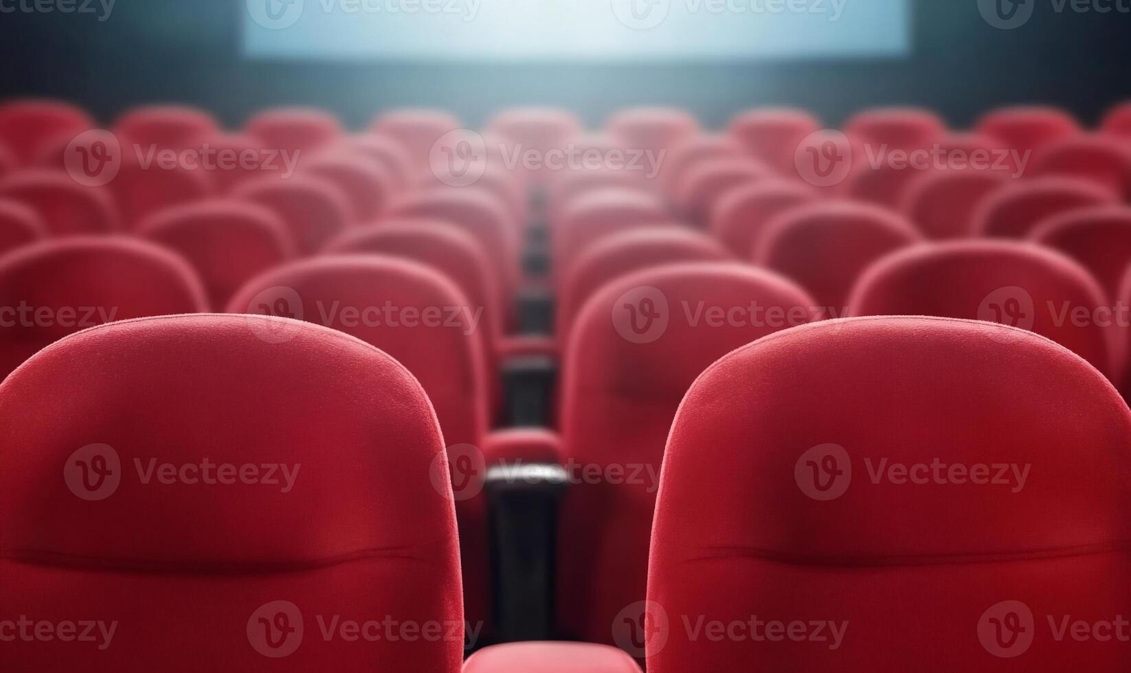 A row of red cinema seats in a theater setting. photo