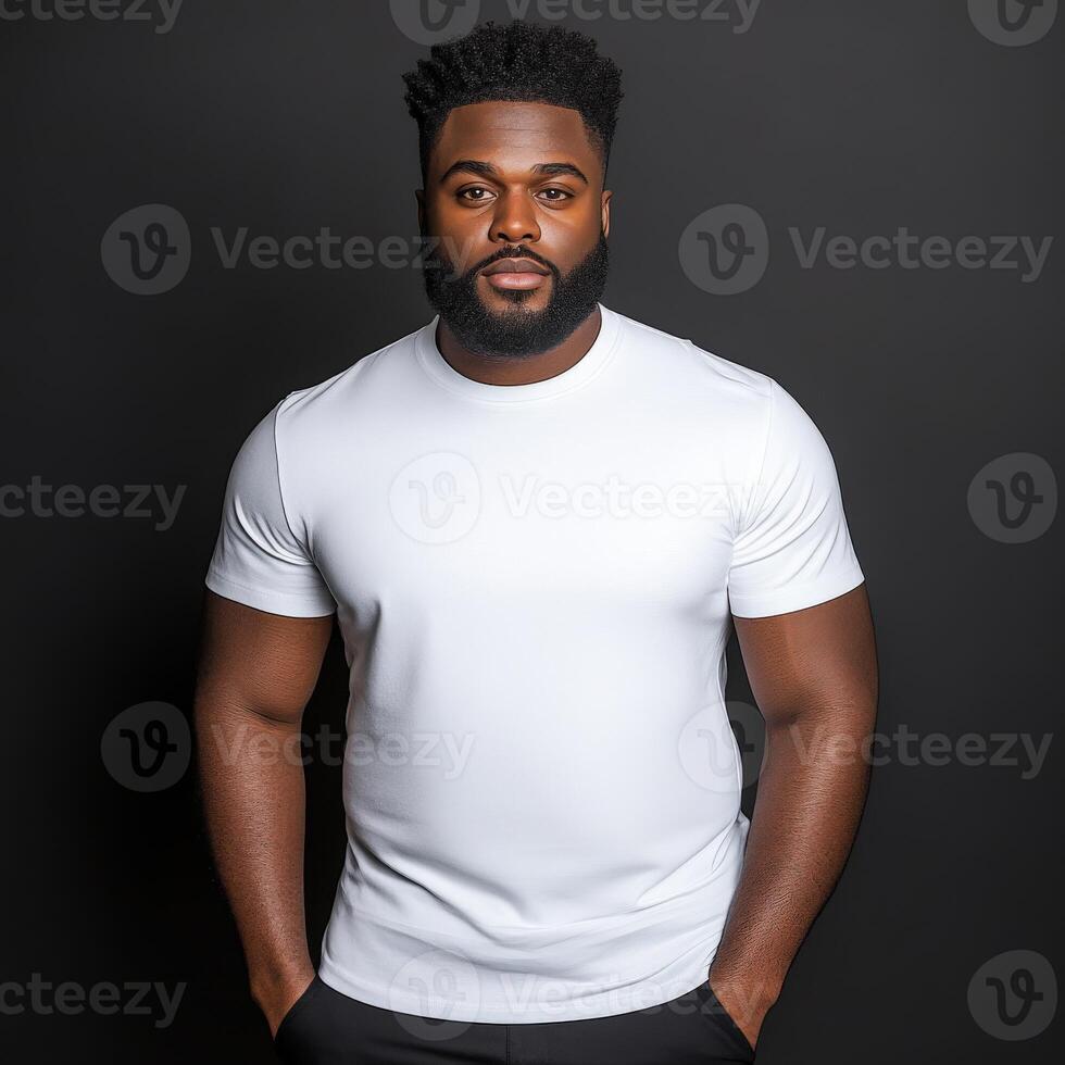 Confident pose of a man wearing a simple white t-shirt in studio setting photo