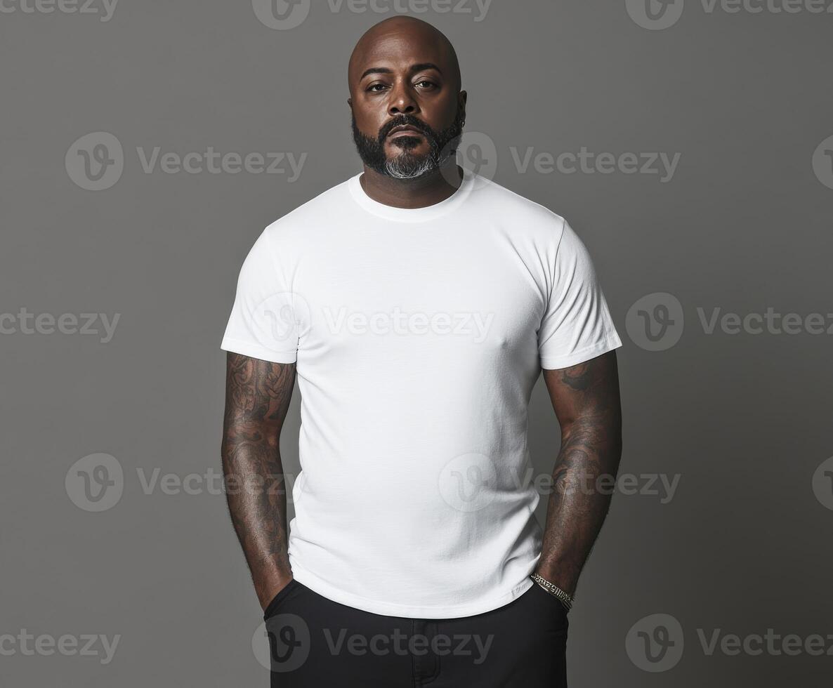 Confident individual poses in casual attire against a gray backdrop photo
