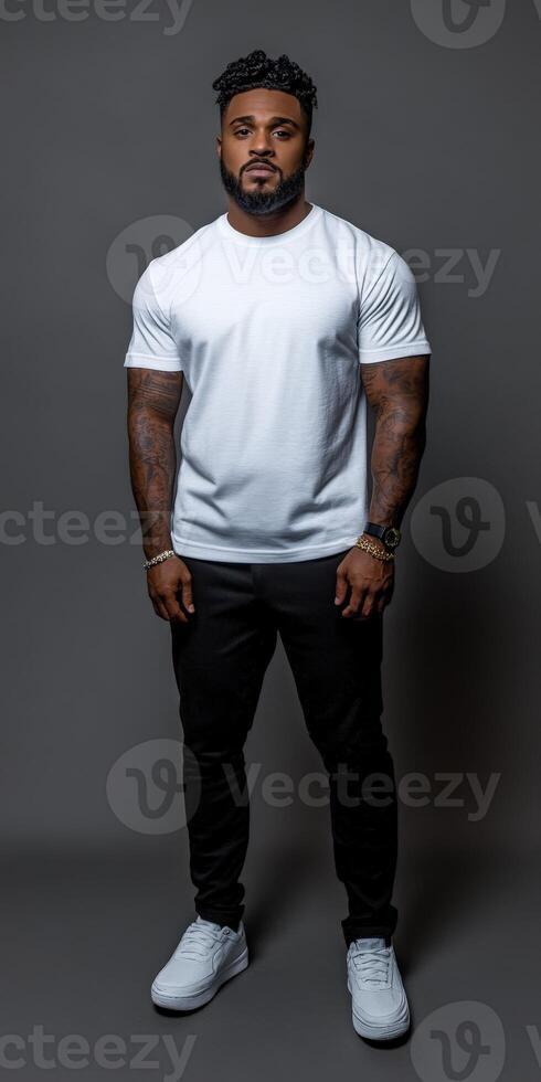 Strong man poses confidently in neutral background with casual attire photo