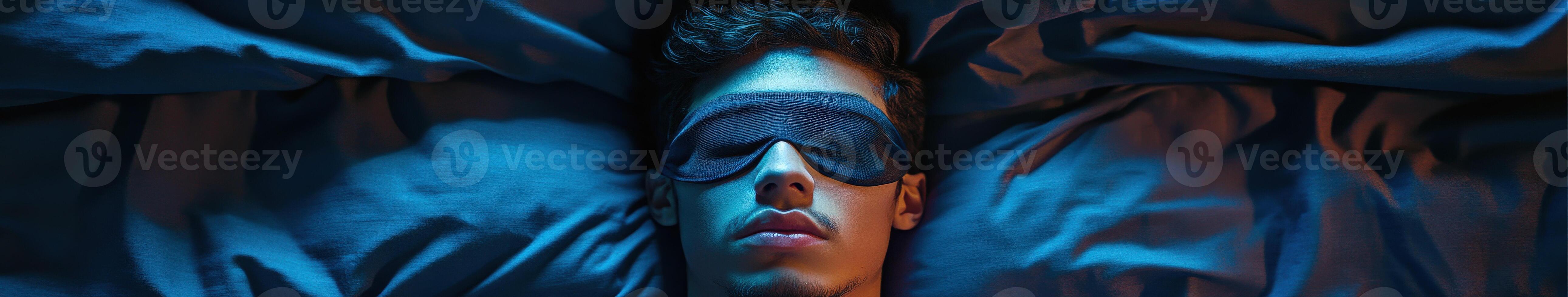 Person resting peacefully with sleep mask in dimly lit bedroom setting photo