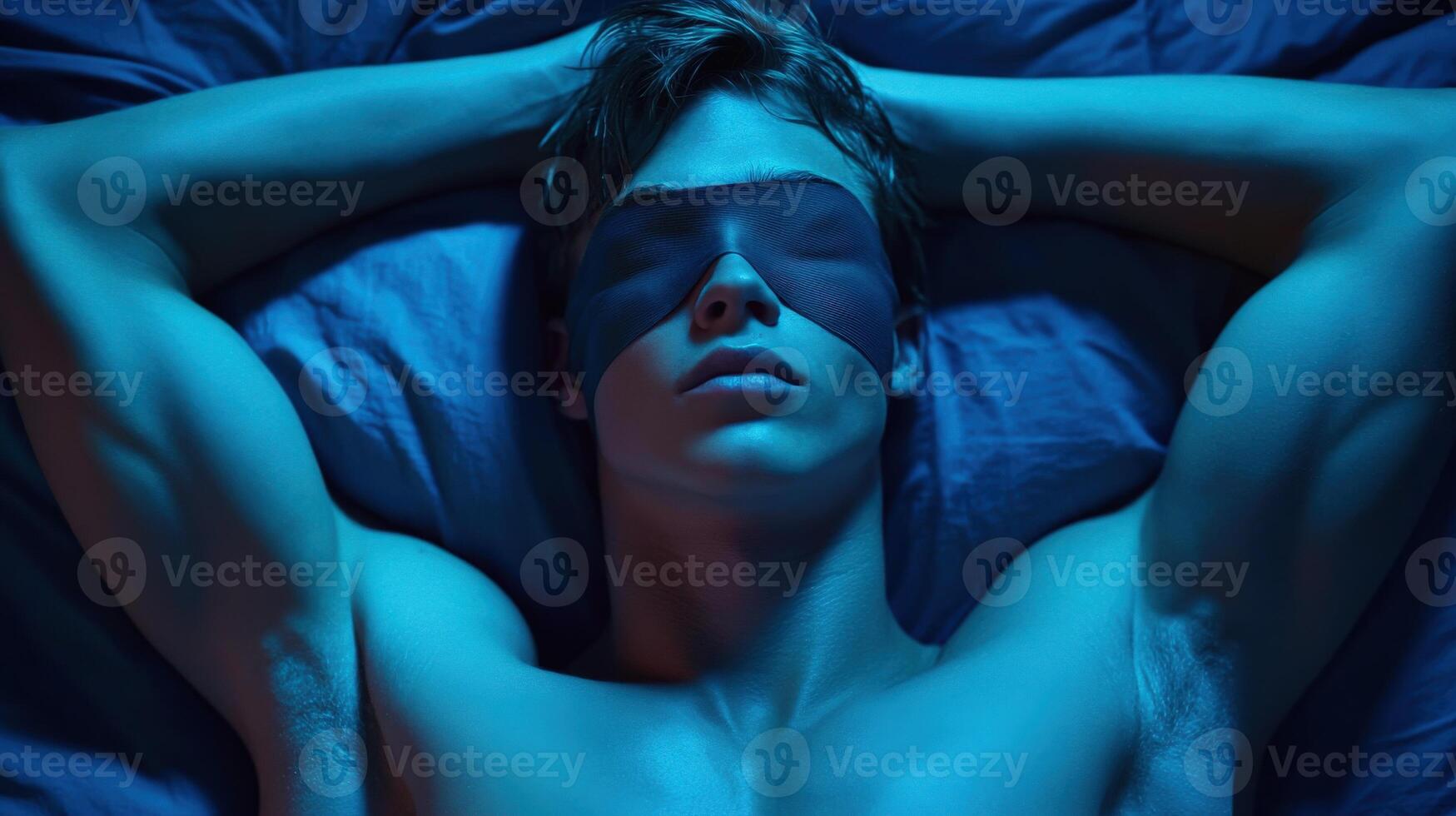 Young man relaxing in a serene environment with a sleep mask on photo