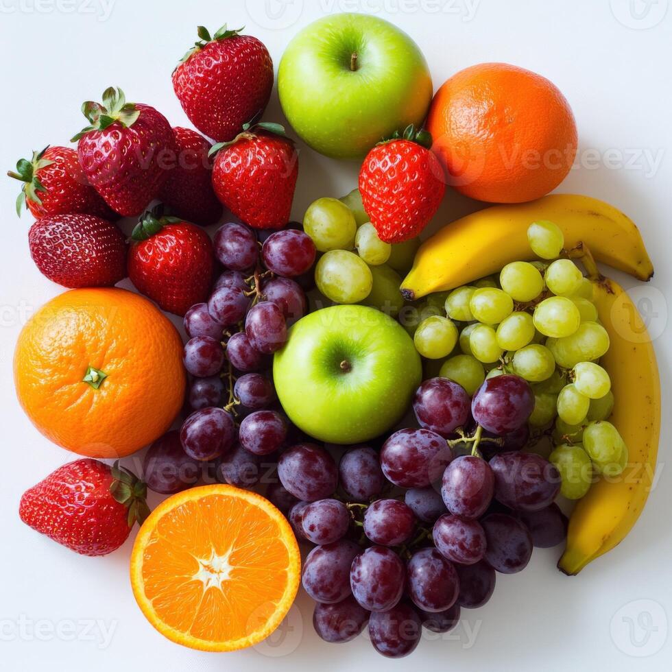 Colorful assortment of fresh fruits arranged on a white surface photo