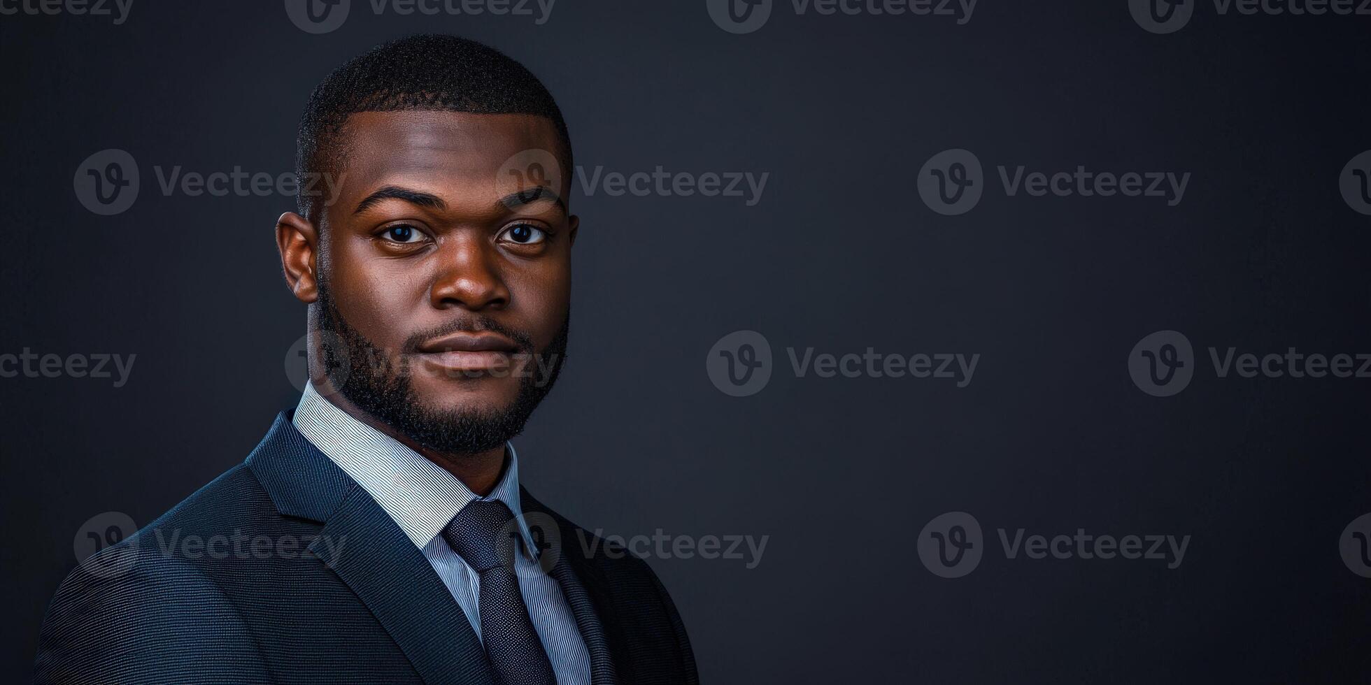 Professional portrait of a man in formal attire against a dark background photo