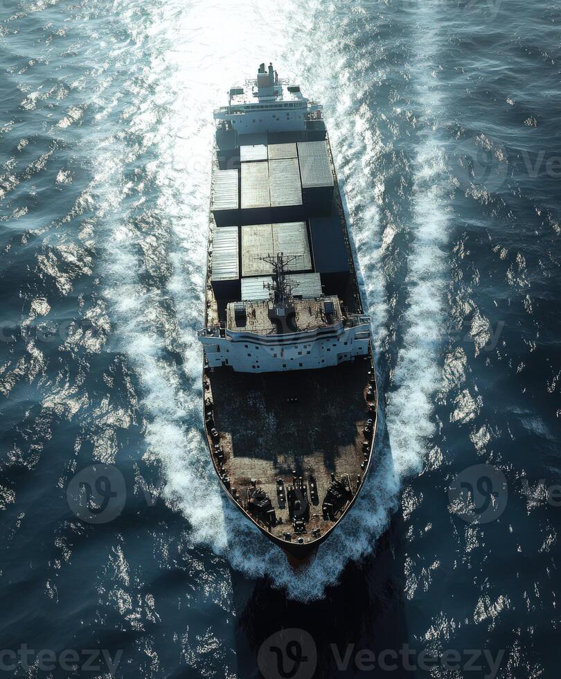 Container ship navigating through deep blue ocean waters at sunrise photo