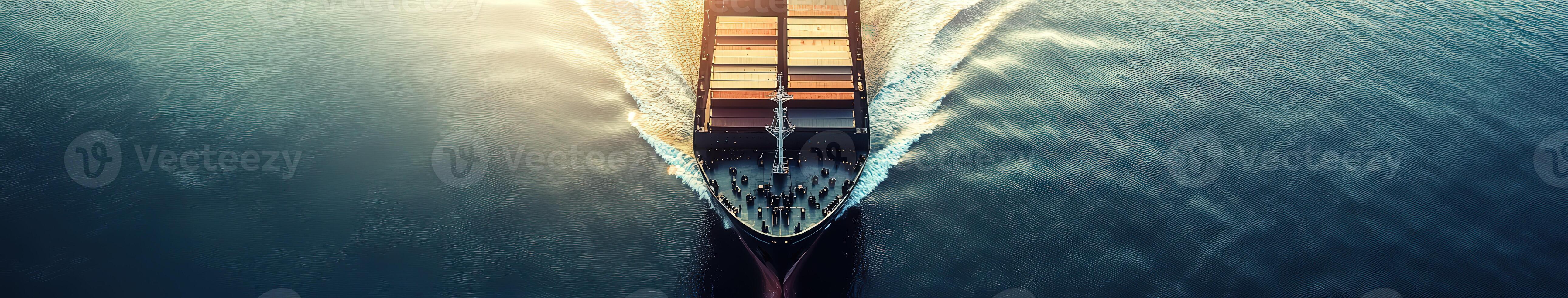 Cargo ship navigating through calm waters during sunset near coastline photo