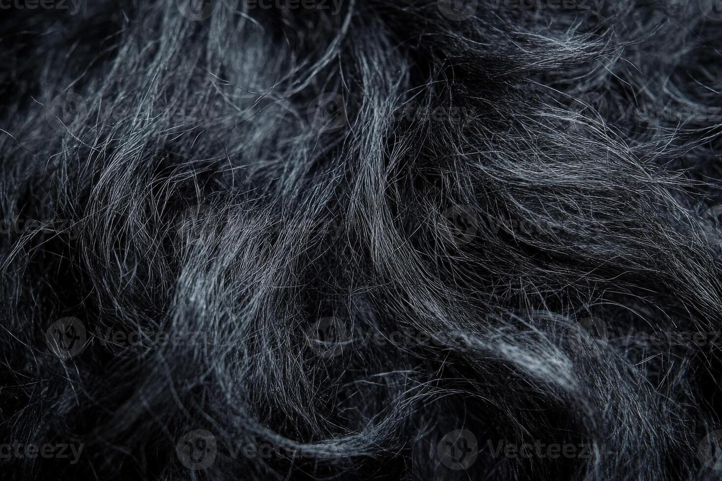 Close-up view of black wool fibers showcasing texture and detail photo
