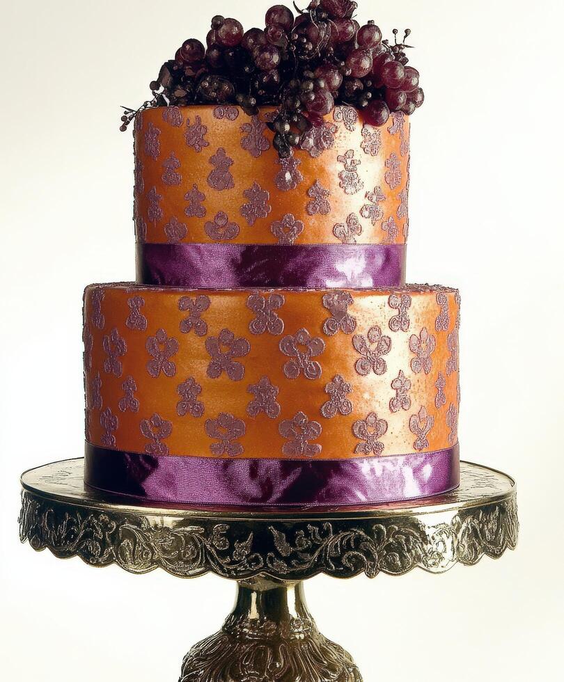 Elegant two-tiered cake adorned with grapes and intricate design photo