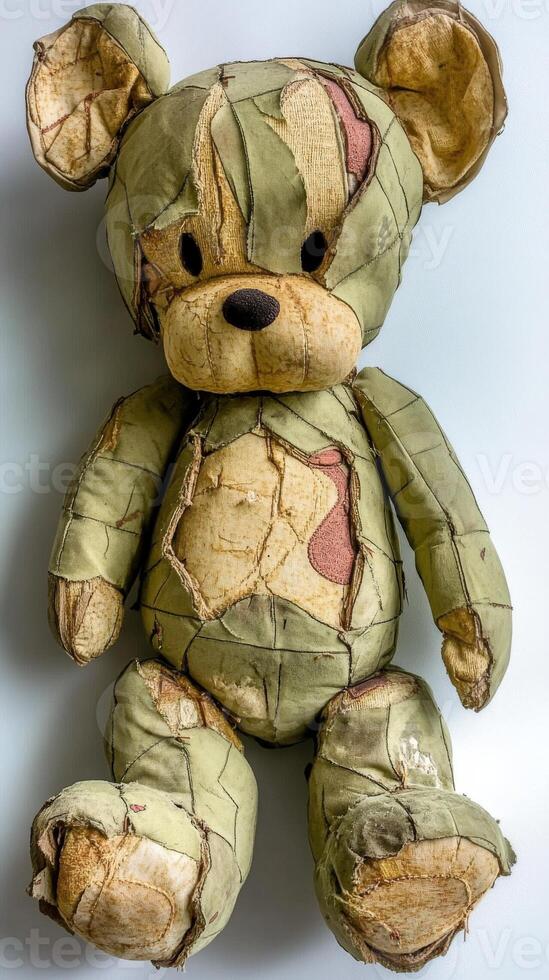 Unique teddy bear covered in patchwork fabric with a worn appearance photo